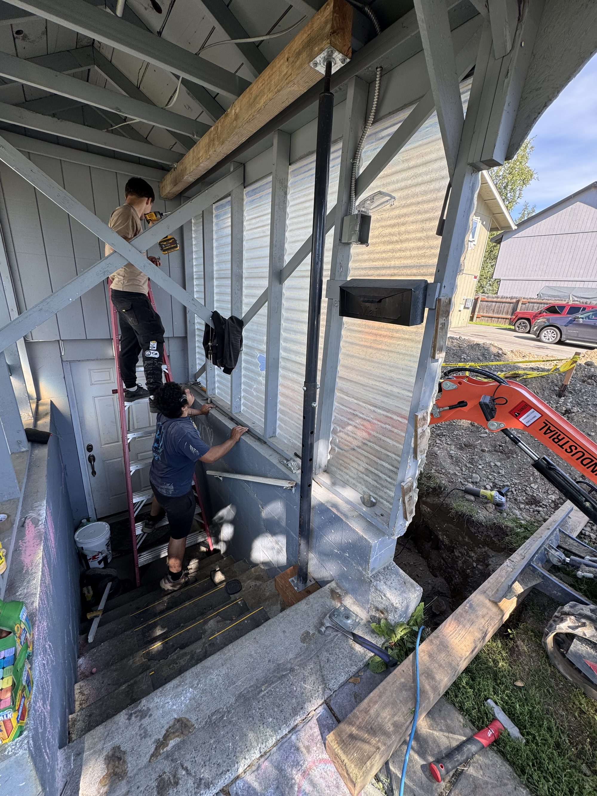 Top Notch crew working with an excavator beneath a shored structure