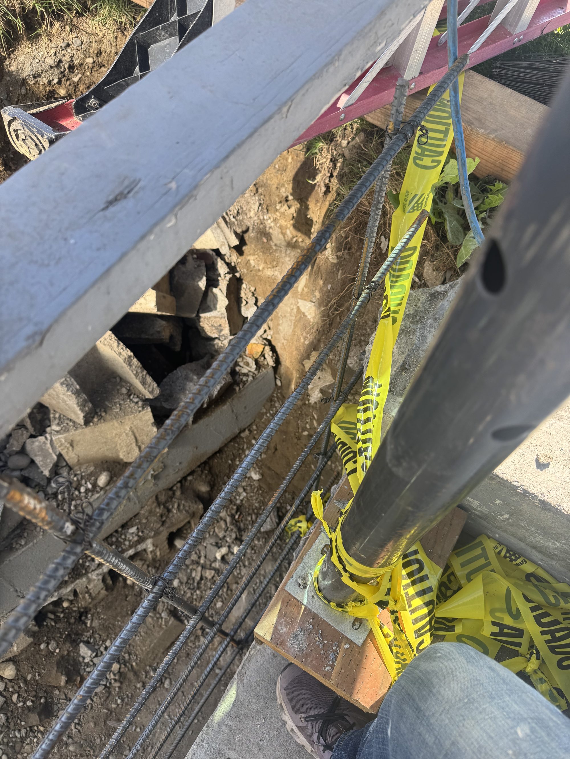 Rebar and shoring in place during a retaining wall rebuild