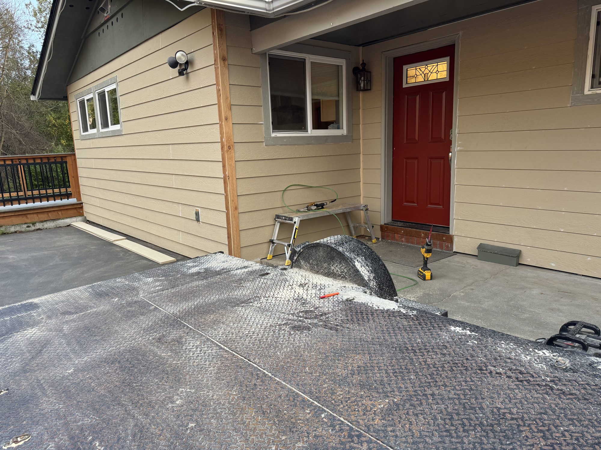 Finished exterior siding remodel with new lap siding, trim, and red door