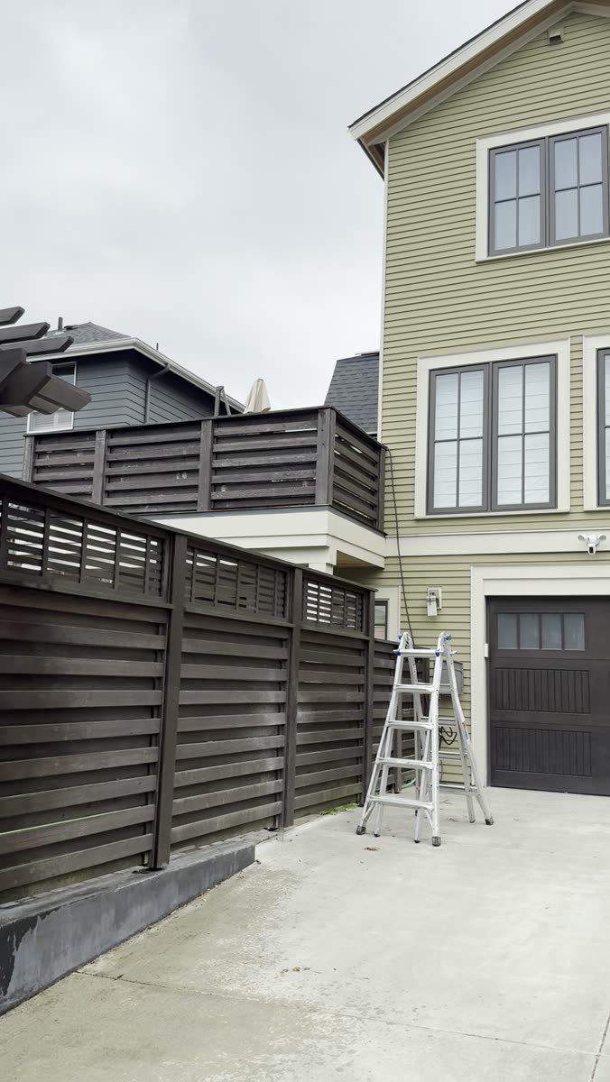 Driveway washed clean beside the fence job