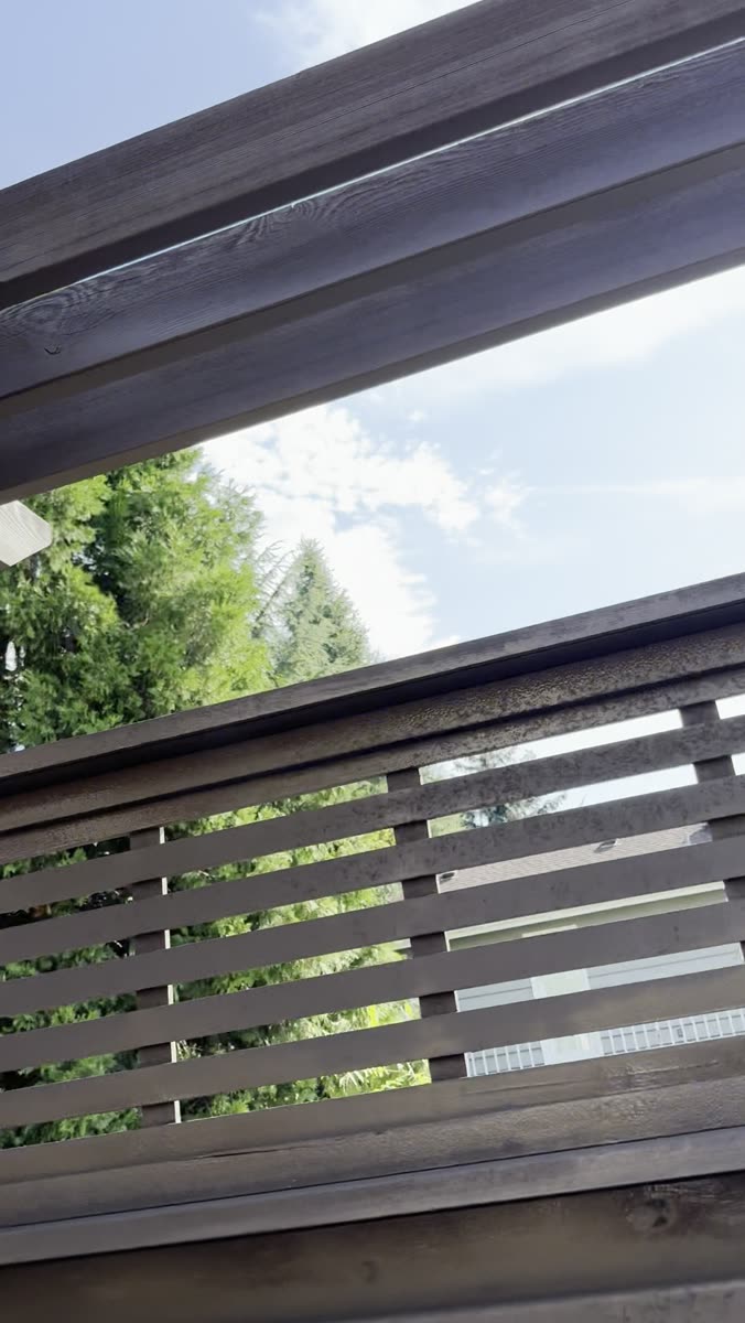 Finished horizontal slat fence after pressure washing and re-staining