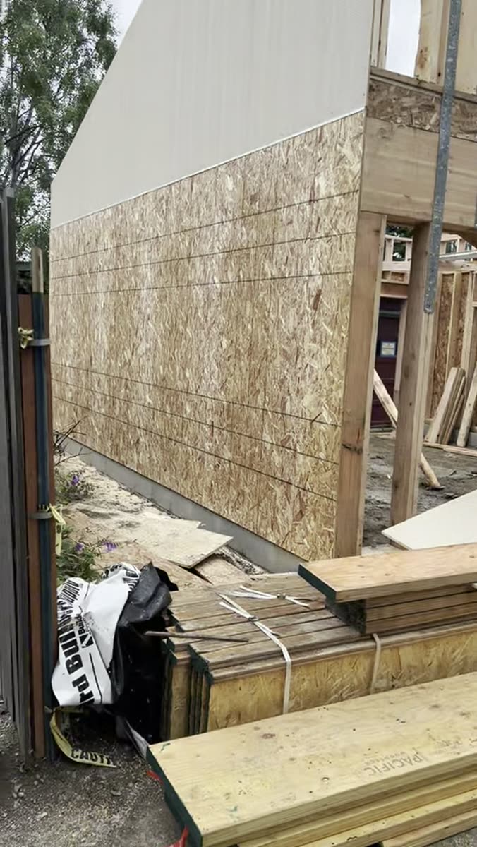 Walkaround of a detached garage under construction, framing and sheathing in place