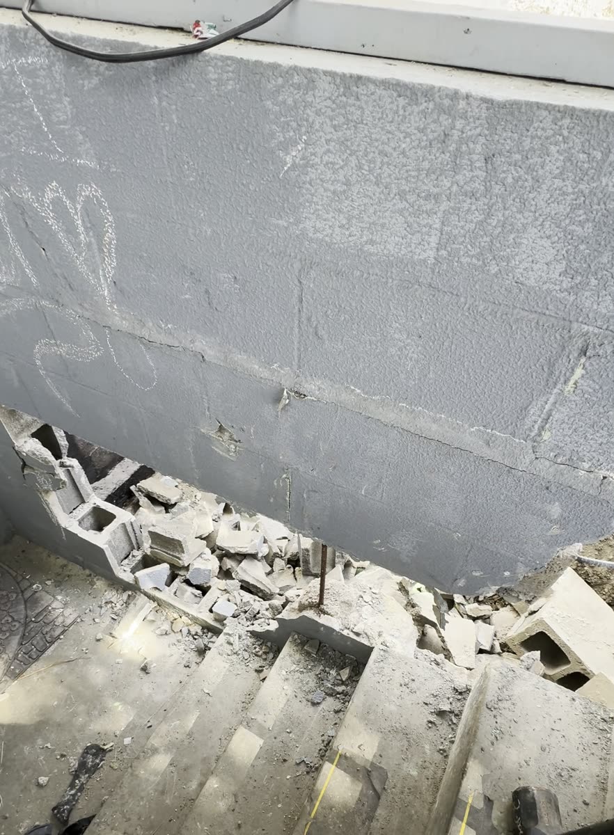 The failing stairwell wall before the retaining wall rebuild